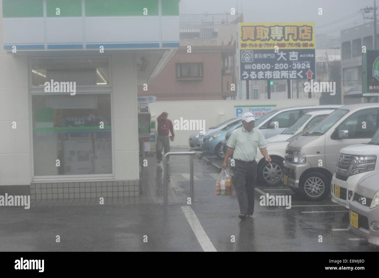 Okinawa, Japan. 11th Oct, 2014. 12.51PM some Okinawans make a final rush to the Family Mart 24-hour convenience store before it closes at 1pm due to the strength of Super Typhoon Vongfong. Credit:  Chris Willson/Alamy Live News Stock Photo