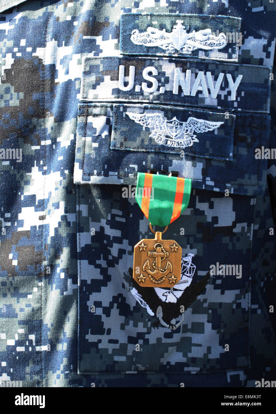 A Navy and Marine Corps Achievement Medal adorns the U.S. Navy uniform. Stock Photo