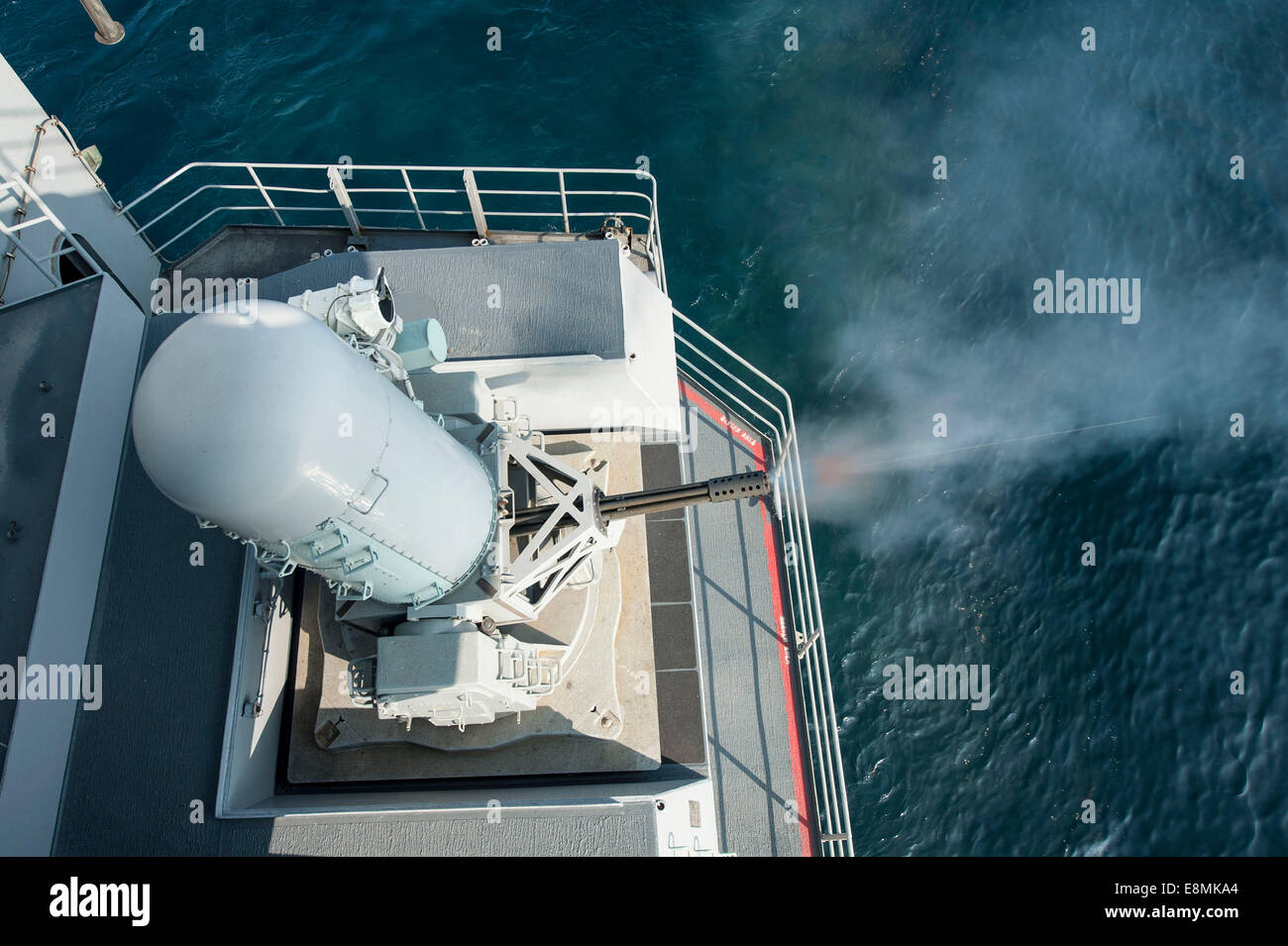 Gulf of Oman, February 2, 2014 - A close-in weapons system fires during a calibration test on board the aircraft carrier USS Har Stock Photo