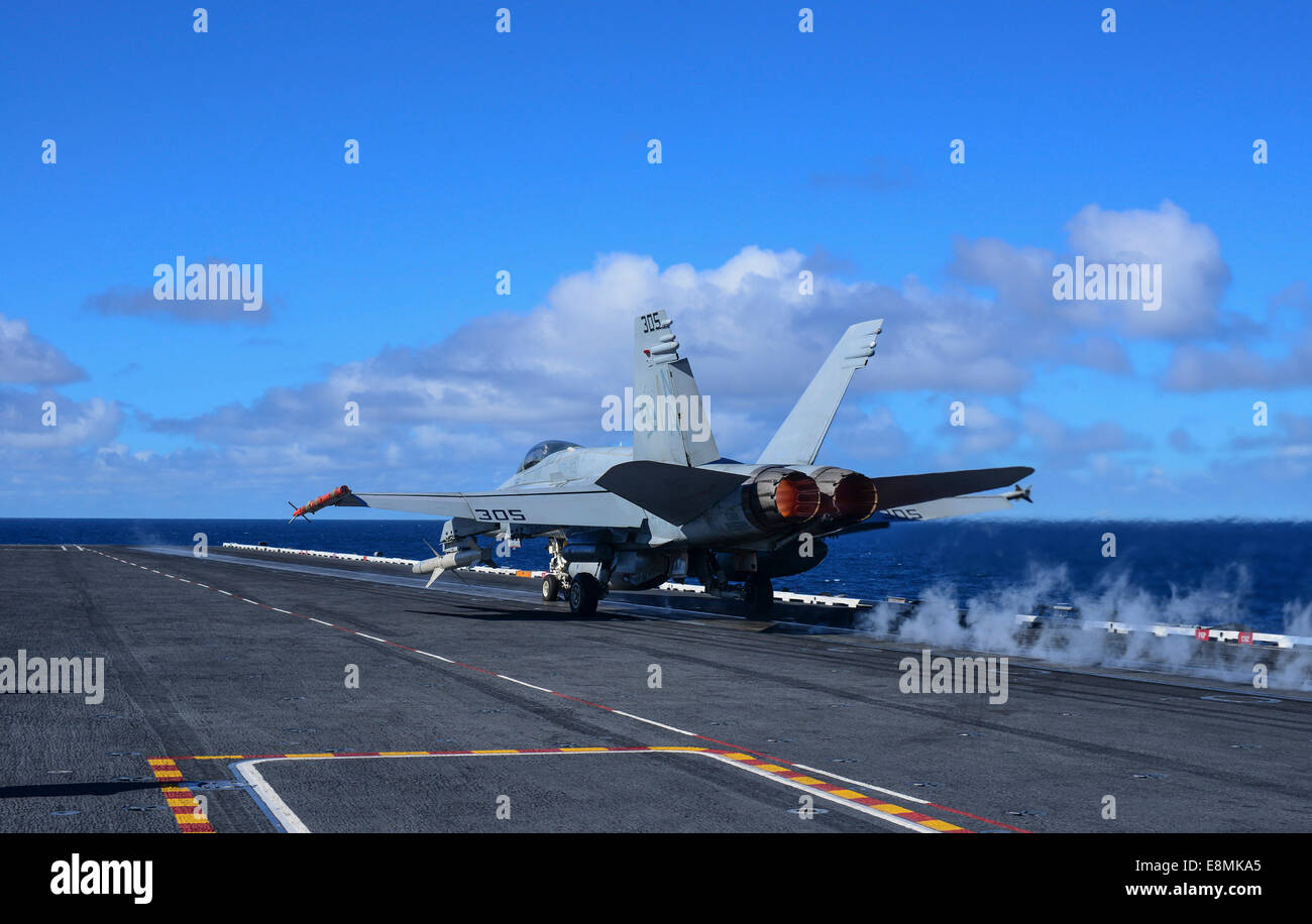 Pacific Ocean, February 3, 2014 - An F/A-18C Hornet launches from aircraft carrier USS Carl Vinson (CVN 70). Stock Photo