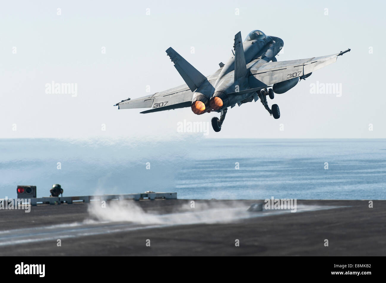 Gulf of Oman, March 19, 2014 - An F/A-18C Hornet launches from the flight deck of the aircraft carrier USS Harry S. Truman (CVN Stock Photo