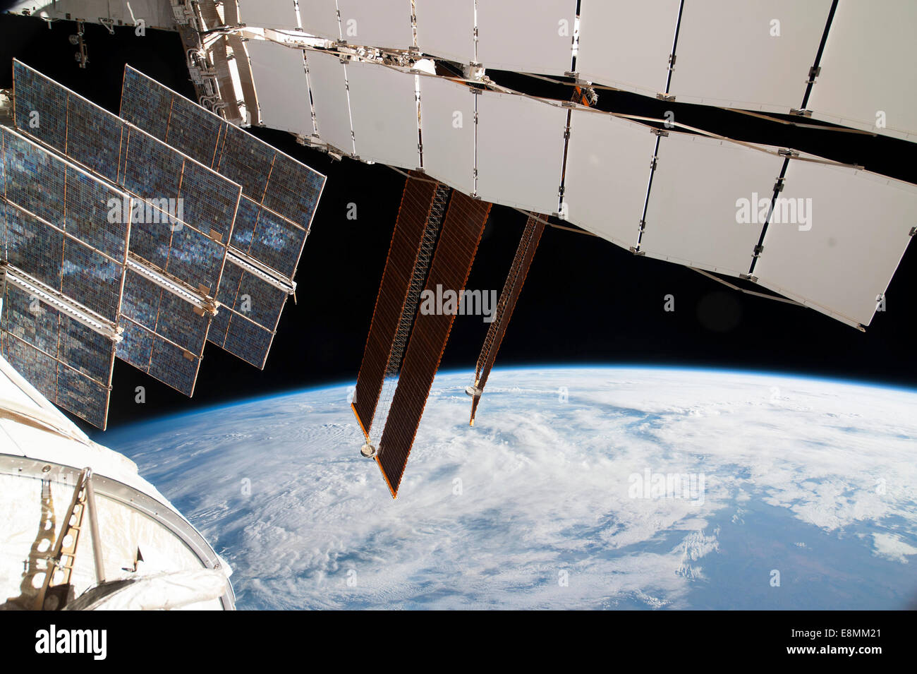 February 5, 2014 - Solar array panels on the Russian segment of the International Space Station and a blue and white part of Ear Stock Photo