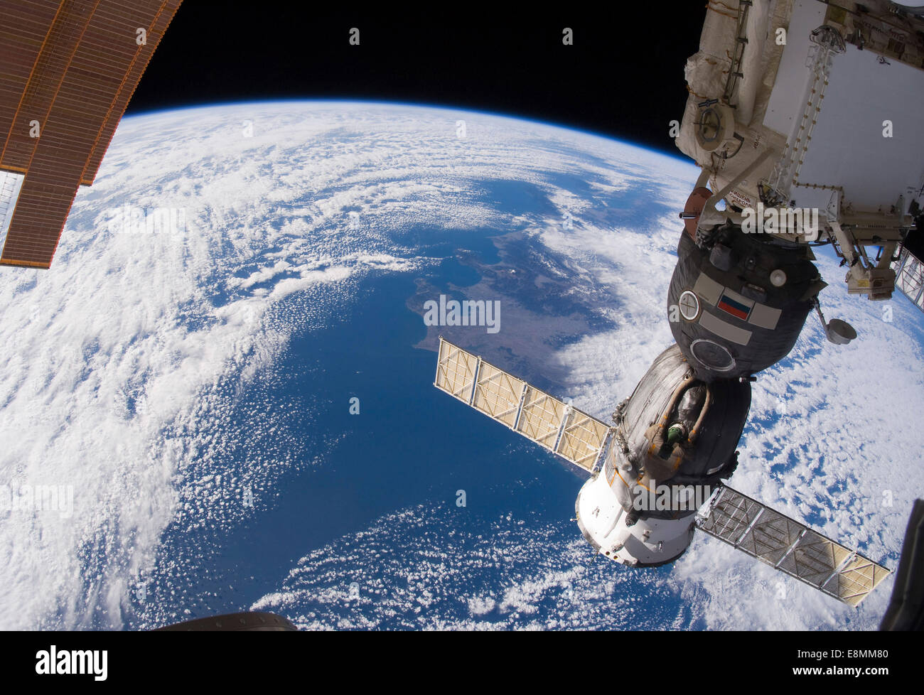 January 31, 2011 - A Russian Soyuz spacecraft docked to the International Space Station. A blue and white part of Earth and the Stock Photo
