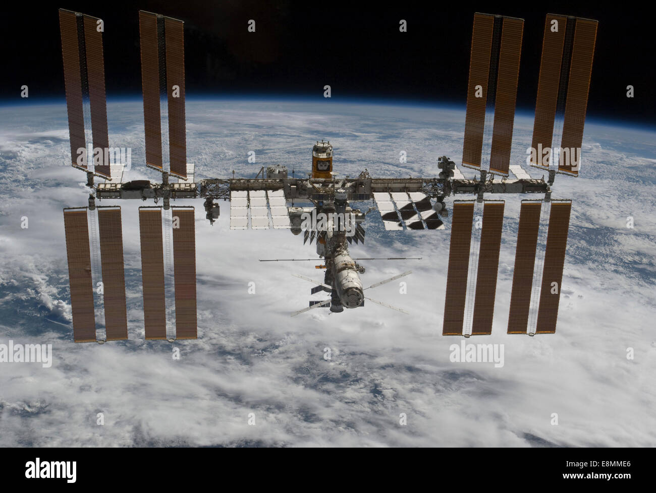 March 7, 2011 - The International Space Station backdropped against clouds over Earth. Stock Photo