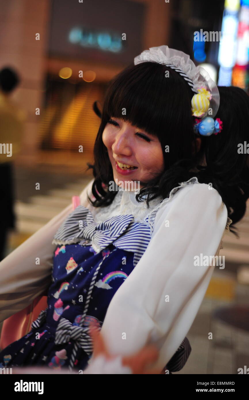 Tokyo, Japan - May 26, 2014: A young woman dressed in Lolita street fashion enjoying the evening in front of Ikebukuro Station. Stock Photo