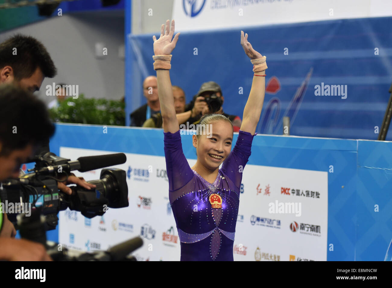 Nanning, China's Guangxi Zhuang Autonomous Region. 11th Oct, 2014. Chinese gymnast Yao Jinnan smiles after her uneven bars performance during the women's individual apparatus finals of the 45th Gymnastics World Championships in Nanning, capital of south China's Guangxi Zhuang Autonomous Region, Oct. 11, 2014. Yao Jinnan won the gold medal in the women's uneven bars final with 15.633 points. Credit:  Yang Zongyou/Xinhua/Alamy Live News Stock Photo