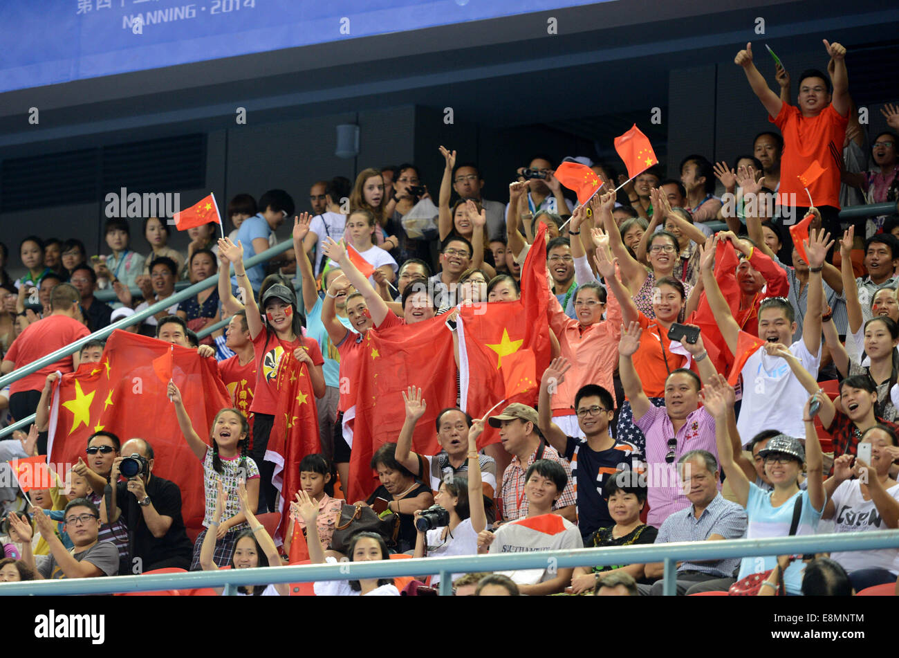 Nanning, China's Guangxi Zhuang Autonomous Region. 11th Oct, 2014. Chinese spectators display national flags of China during the individual apparatus finals of the 45th Gymnastics World Championships in Nanning, capital of south China's Guangxi Zhuang Autonomous Region, Oct. 11, 2014. Credit:  Wang Yuguo/Xinhua/Alamy Live News Stock Photo