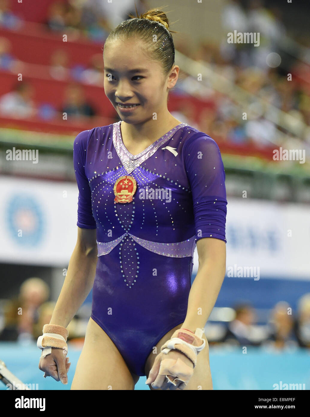 Nanning, China's Guangxi Zhuang Autonomous Region. 11th Oct, 2014. Chinese gymnast Yao Jinnan reacts after her uneven bars performance during the women's individual apparatus finals of the 45th Gymnastics World Championships in Nanning, capital of south China's Guangxi Zhuang Autonomous Region, Oct. 11, 2014. Yao Jinnan won the gold medal in the women's uneven bars final with 15.633 points. Credit:  Yang Zongyou/Xinhua/Alamy Live News Stock Photo