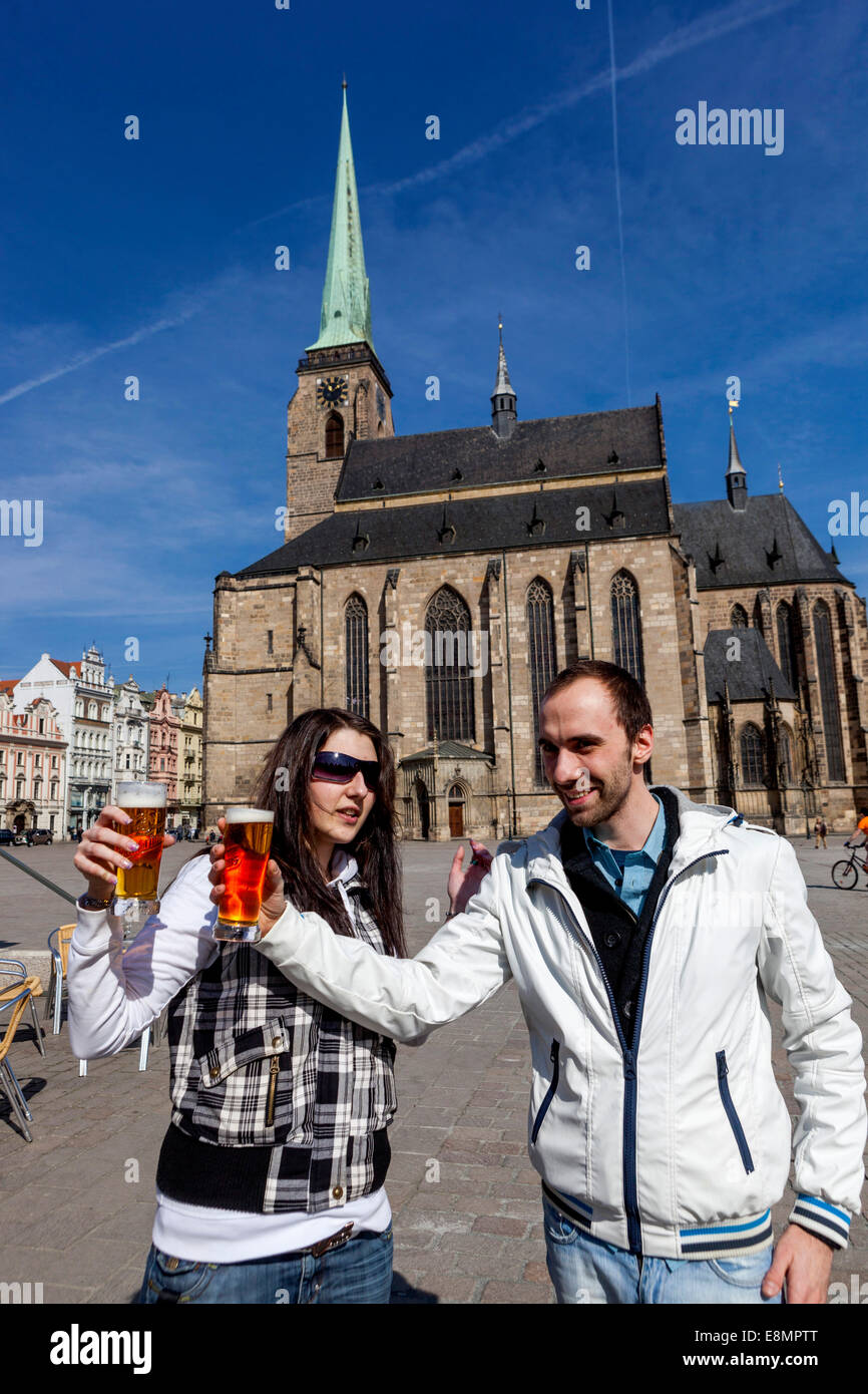 Cathedral of St. Bartholomew and pair with a beer front of it, Plzen Czech Republic Stock Photo