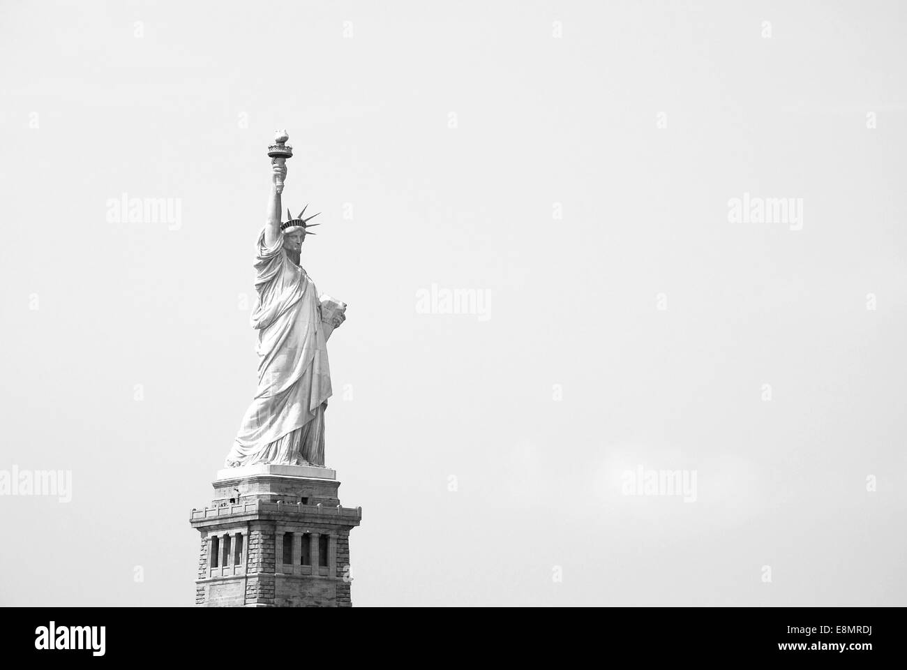 The Statue of Liberty stands proudly against a clear sky - monochrome processing Stock Photo