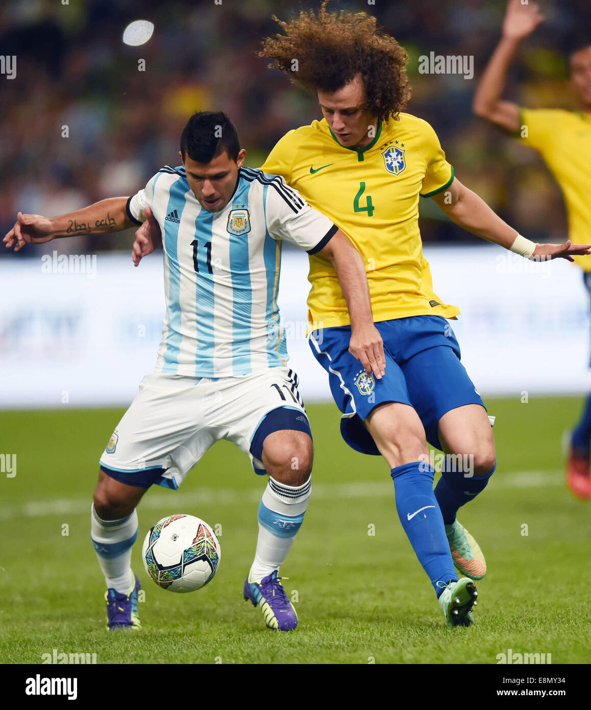 Beijing, China. 11th Oct, 2014. Argentina's Sergio Aguero (L) controls the ball during a friendly match against Brazil in Beijing, capital of China, Oct. 11, 2014. Credit:  Guo Yong/Xinhua/Alamy Live News Stock Photo