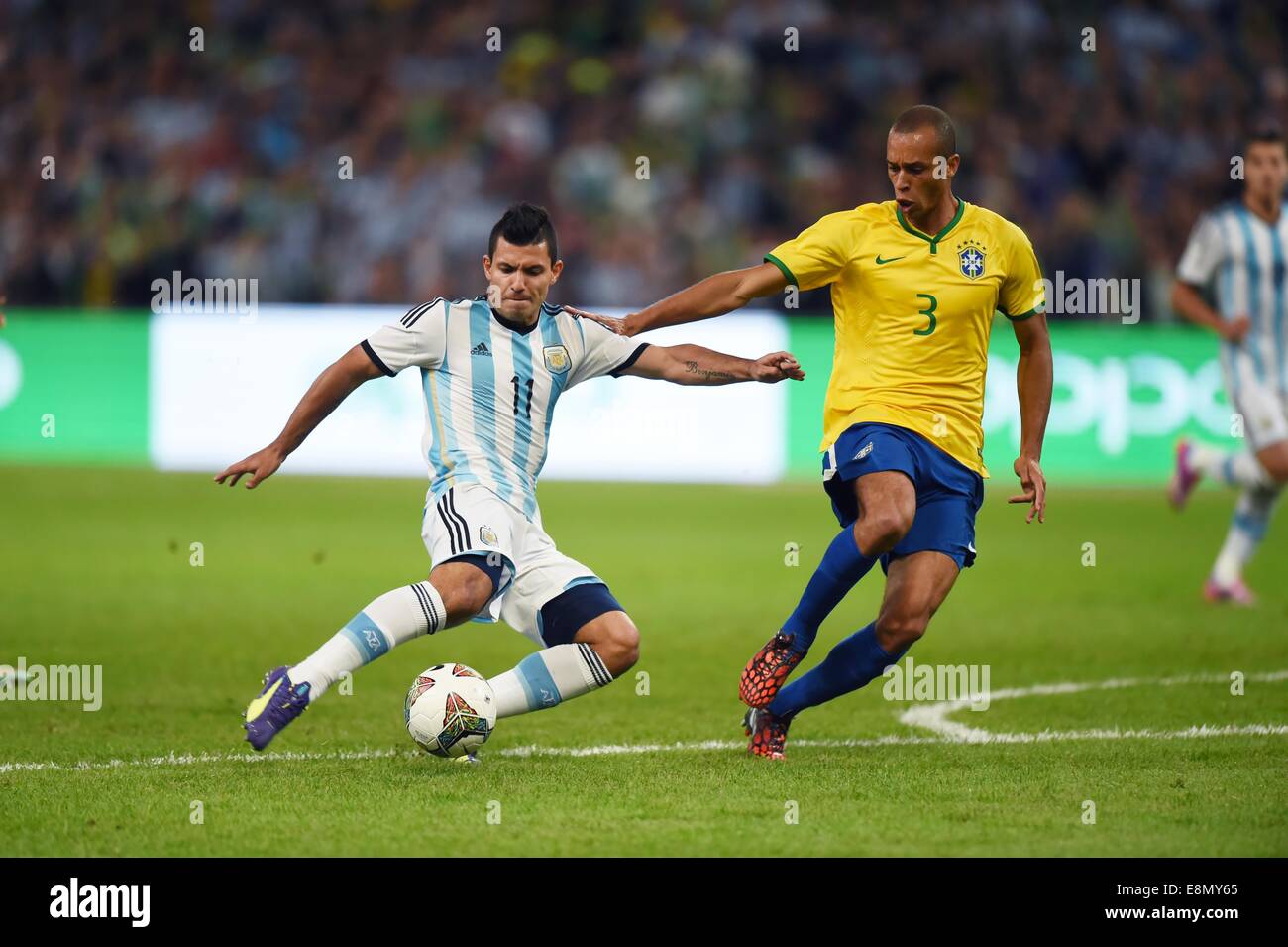 Beijing, China. 11th Oct, 2014. Argentina's Sergio Aguero (L) vies with Brazil's Miranda during a friendly match in Beijing, capital of China, Oct. 11, 2014. Credit:  Guo Yong/Xinhua/Alamy Live News Stock Photo