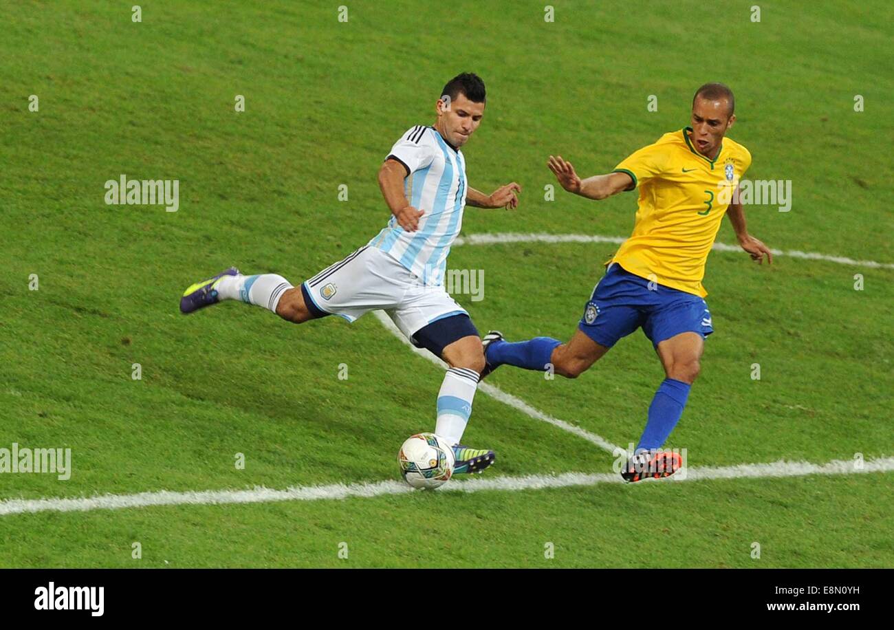 Beijing, China. 11th Oct, 2014. Argentina's Sergio Aguero (L) vies with Brazil's Miranda during a friendly match in Beijing, capital of China, Oct. 11, 2014. Credit:  Fei Maohua/Xinhua/Alamy Live News Stock Photo