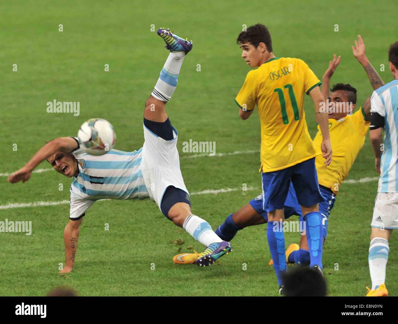 Beijing, China. 11th Oct, 2014. Argentina's Sergio Aguero (L) falls down during a friendly match against Brazil in Beijing, capital of China, Oct. 11, 2014. Credit:  Li Wen/Xinhua/Alamy Live News Stock Photo
