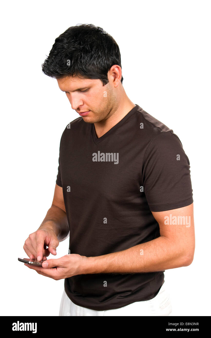 Young man sends a message by texting on his smartphone. Stock Photo