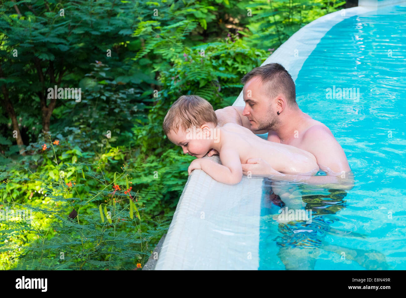 Father with his toddler boy in the swimming pool Stock Photo