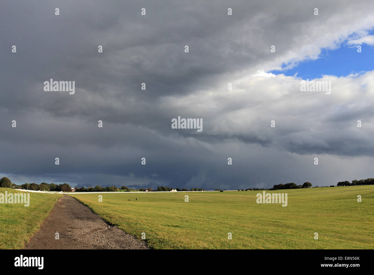 Epsom Downs, Surrey, UK. 11th October 2014. Blue skies alternate with dramatic cumulonimbus rain clouds over Epsom Downs Race Course. Credit:  Julia Gavin UK/Alamy Live News Stock Photo