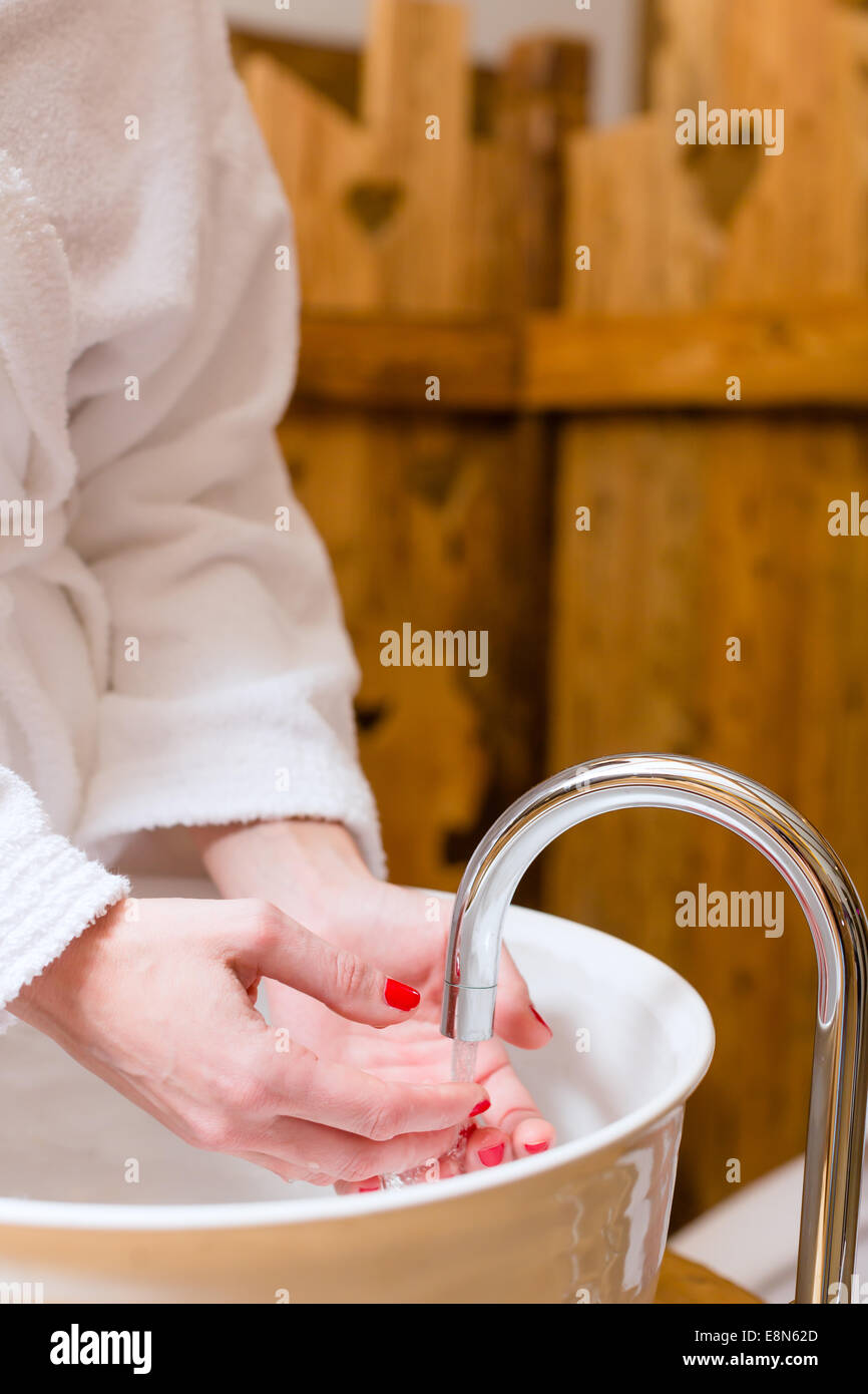 Woman washing hands at wellness spa Stock Photo