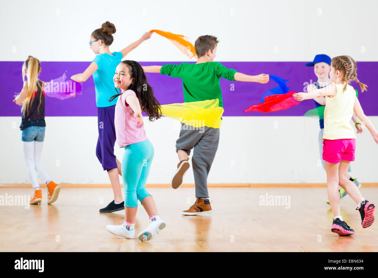 Children dancing modern group choreography with scarfs Stock Photo