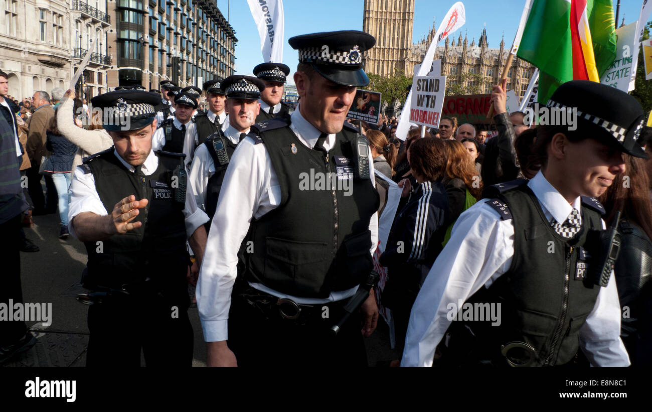 Parliament Square, London UK. 11th October 2014.  Kurdish people gather in Parliament Square in to demonstrate against the overwhelming aggression of ISIS, lack of support in protecting Kurds in the city of Kobane in Syria and wave anti Turkish AKP government placards. London Metropolitan Police officers move through the crowd in to break up scuffles during the demo. Kathy deWitt/Alamy Live News Stock Photo