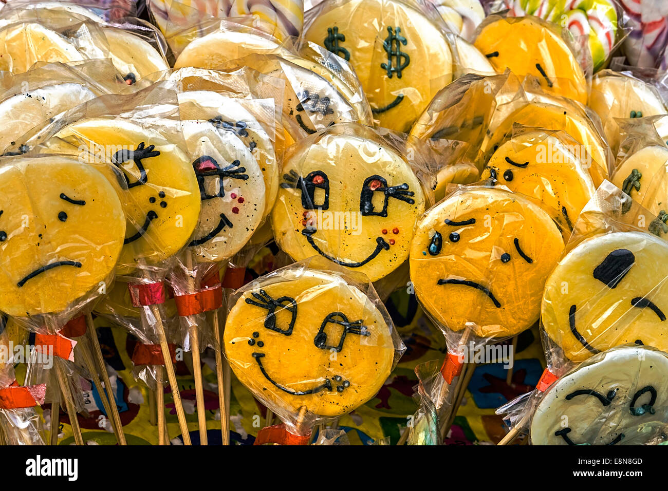 Lots of colorful lollies, symbolizing emoticons, on display for sale ...