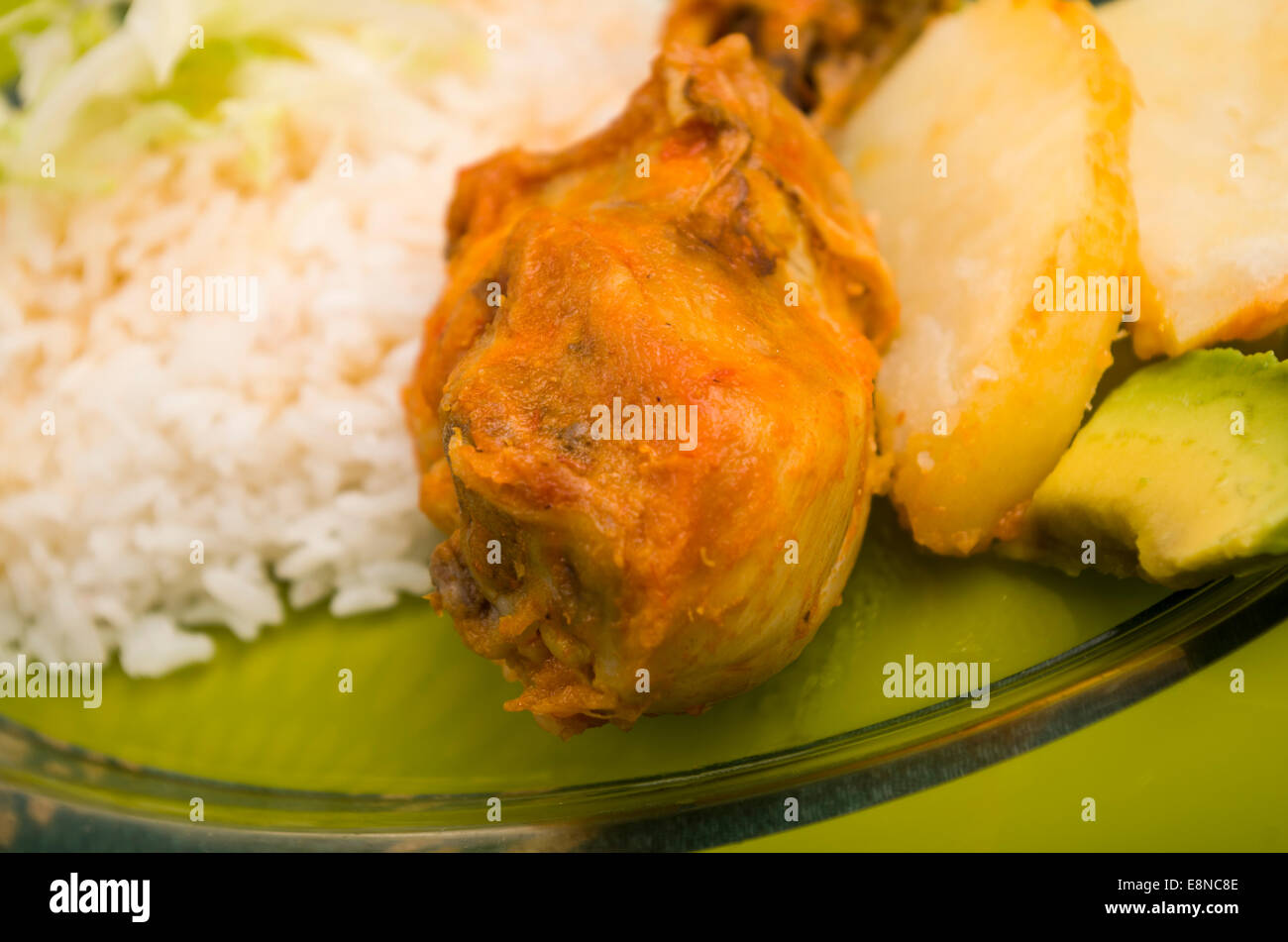 chicken served with white rice potato on a plate Stock Photo - Alamy