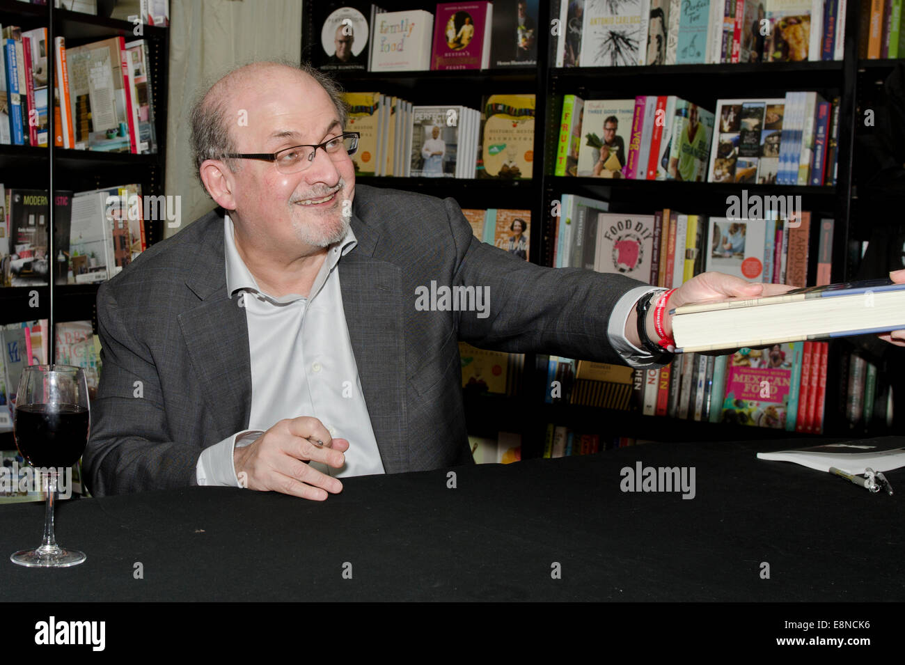 Salman  Rushdie, novelist,  Man Booker Prize winner and writer of Midnight's Children and The Satanic Verses signs books at the Cheltenham Literary Festival Gloucestershire Uk 10th October, 2014. 2014 Credit:  Prixnews/Alamy Live News Stock Photo