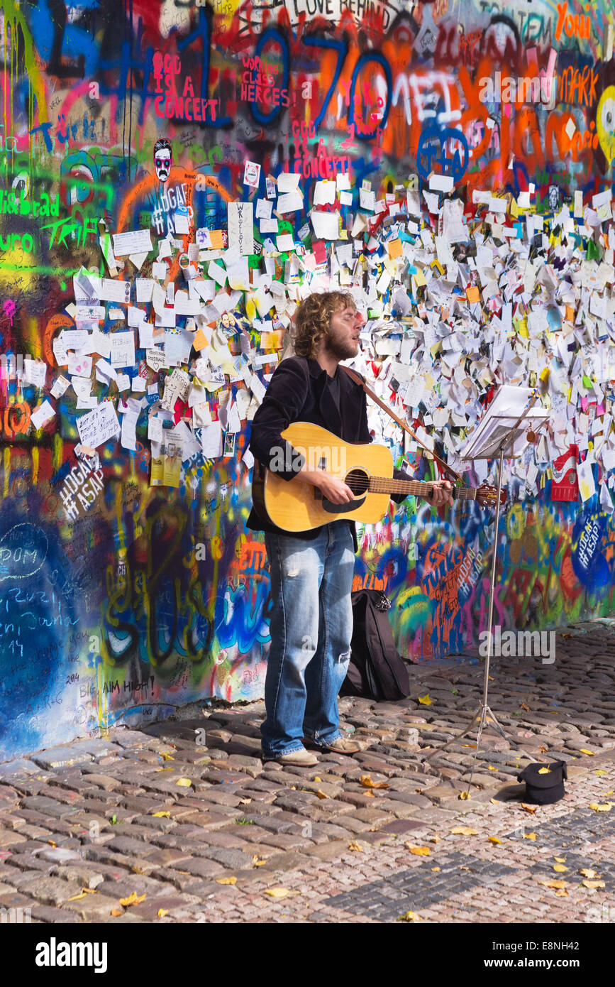 PRAGUE, CZECH REPUBLIC - SEPTEMBER 11, 2014: Street Busker performing Beatles songs in front of FJohn Lennon Wall in Prague Stock Photo