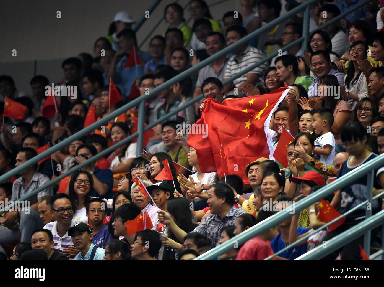 Nanning, China's Guangxi Zhuang Autonomous Region. 12th Oct, 2014. Chinese spectators display national flags of China during the individual apparatus finals of the 45th Gymnastics World Championships in Nanning, capital of south China's Guangxi Zhuang Autonomous Region, Oct. 12, 2014. Credit:  Zhou Hua/Xinhua/Alamy Live News Stock Photo