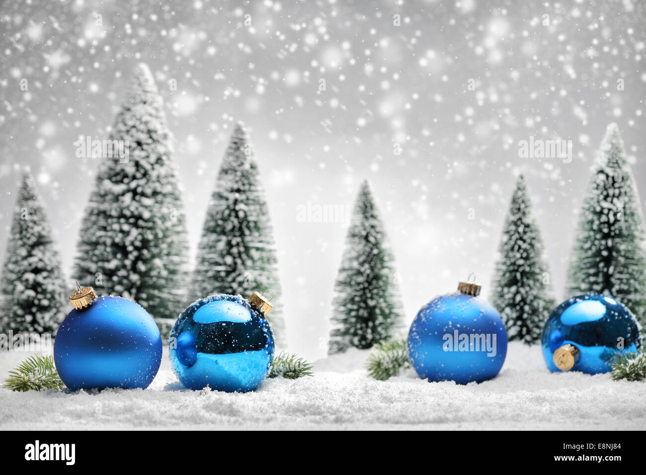 Blue Christmas balls and fir tree on snow Stock Photo