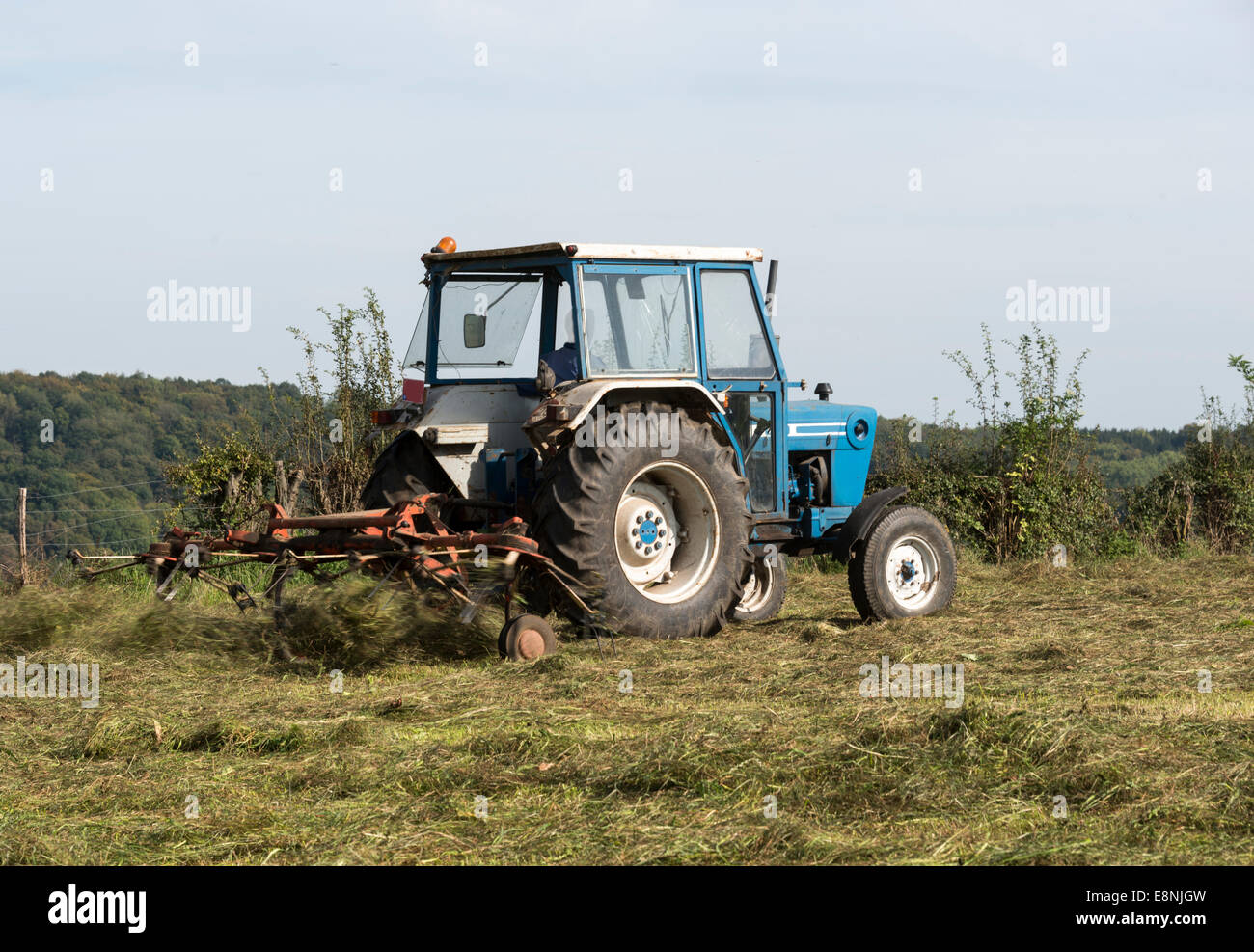 farmer at work with tractor mowing grass Stock Photo Alamy
