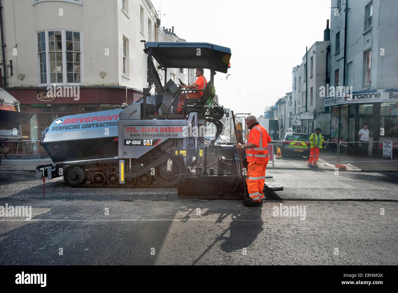 Picture by Roger Bamber : 23 September 2014 : A Caterpiller Road Surfacing Paver resurfaces a Main Road in Brighton East Sussex Stock Photo