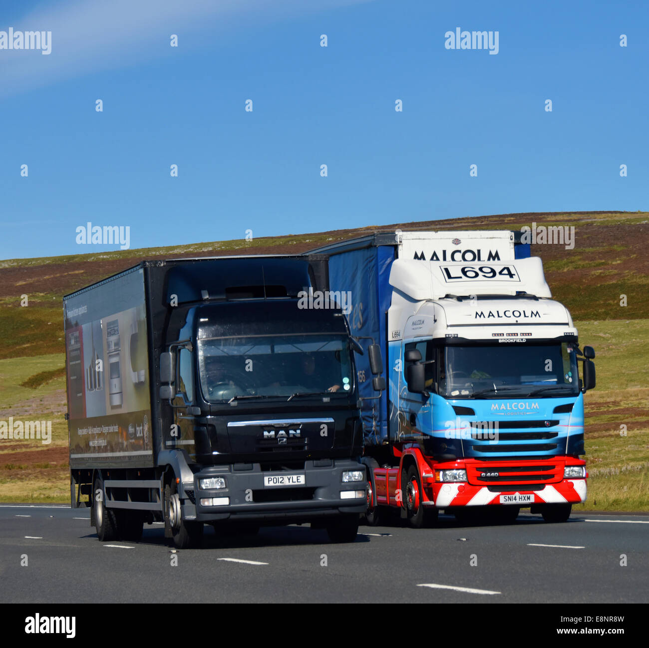 Delivery van and Malcolm Logistics HGV. M6 Motorway, southbound. Shap, Cumbria, England, United Kingdom, Europe. Stock Photo