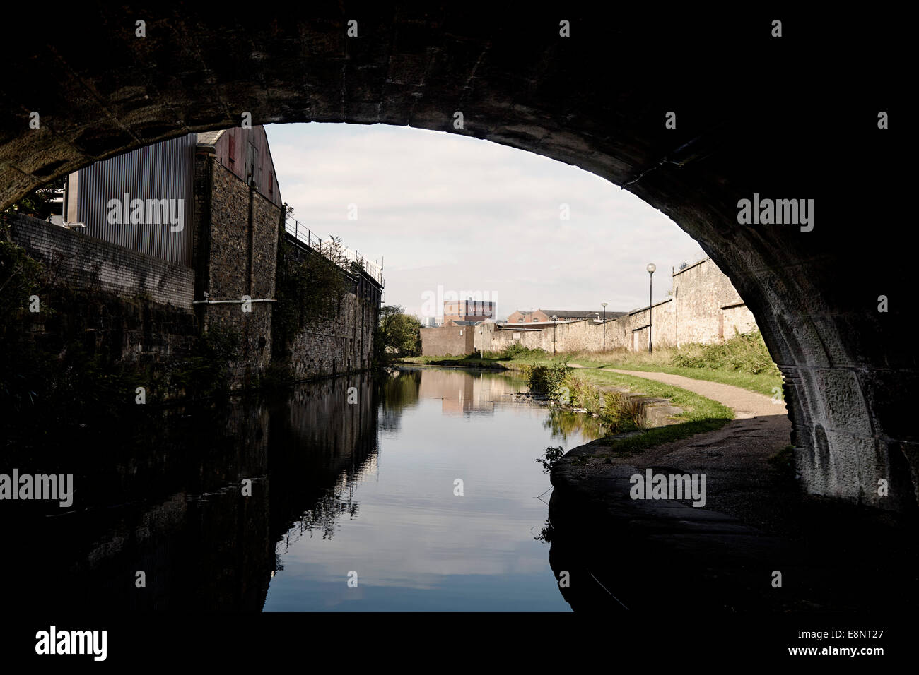 Canal bridge with factories behind in Blackburn on the Leeds and Liverpool canal Stock Photo