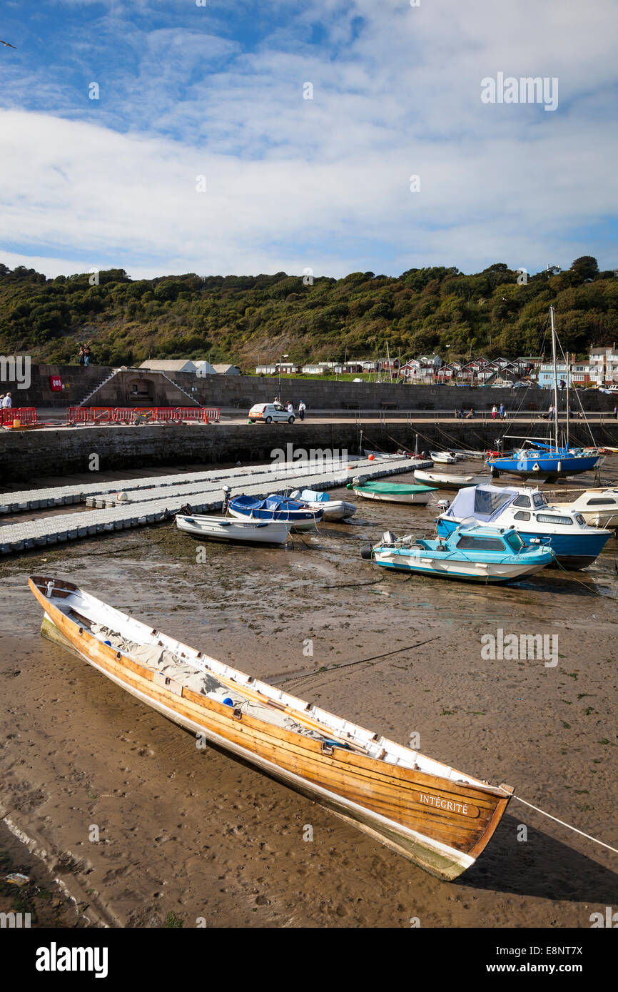 The 'Bantry Bay' gig 'Intégrité' replica lying on the sand at low tide in Lyme Regis harbour. Stock Photo