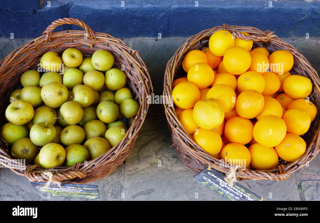Fruit baskets containing oranges and russet apples Stock Photo