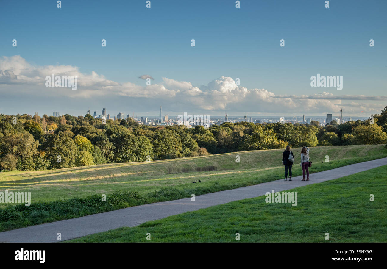 London, UK - 12 October 2014: Two young women look at the view of the London skyline seen from Hampstead Heath Stock Photo