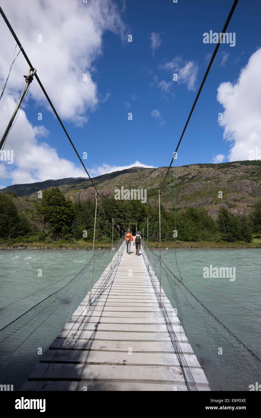 Rope bridge crossing melt-water from Lago Grey, Patagonia, Chile. Stock Photo