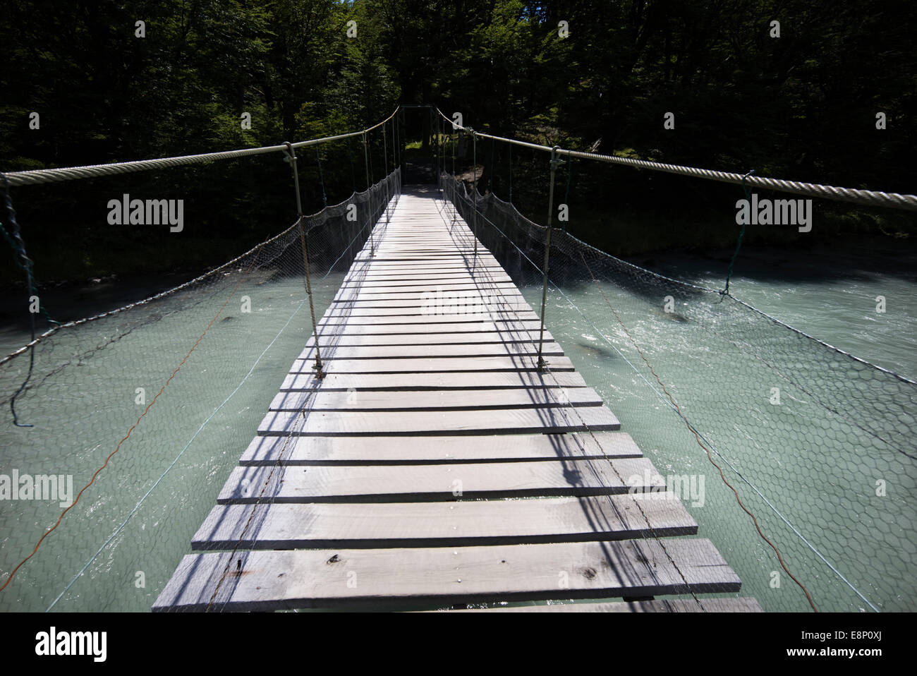 Rope bridge crossing melt-water from Lago Grey, Patagonia, Chile. Stock Photo