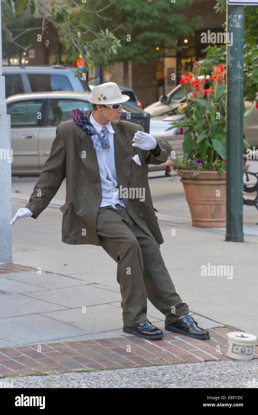 Asheville, North Carolina, USA - September 26, 2014:  A man makes tips as a living statue on the streets downtown Stock Photo