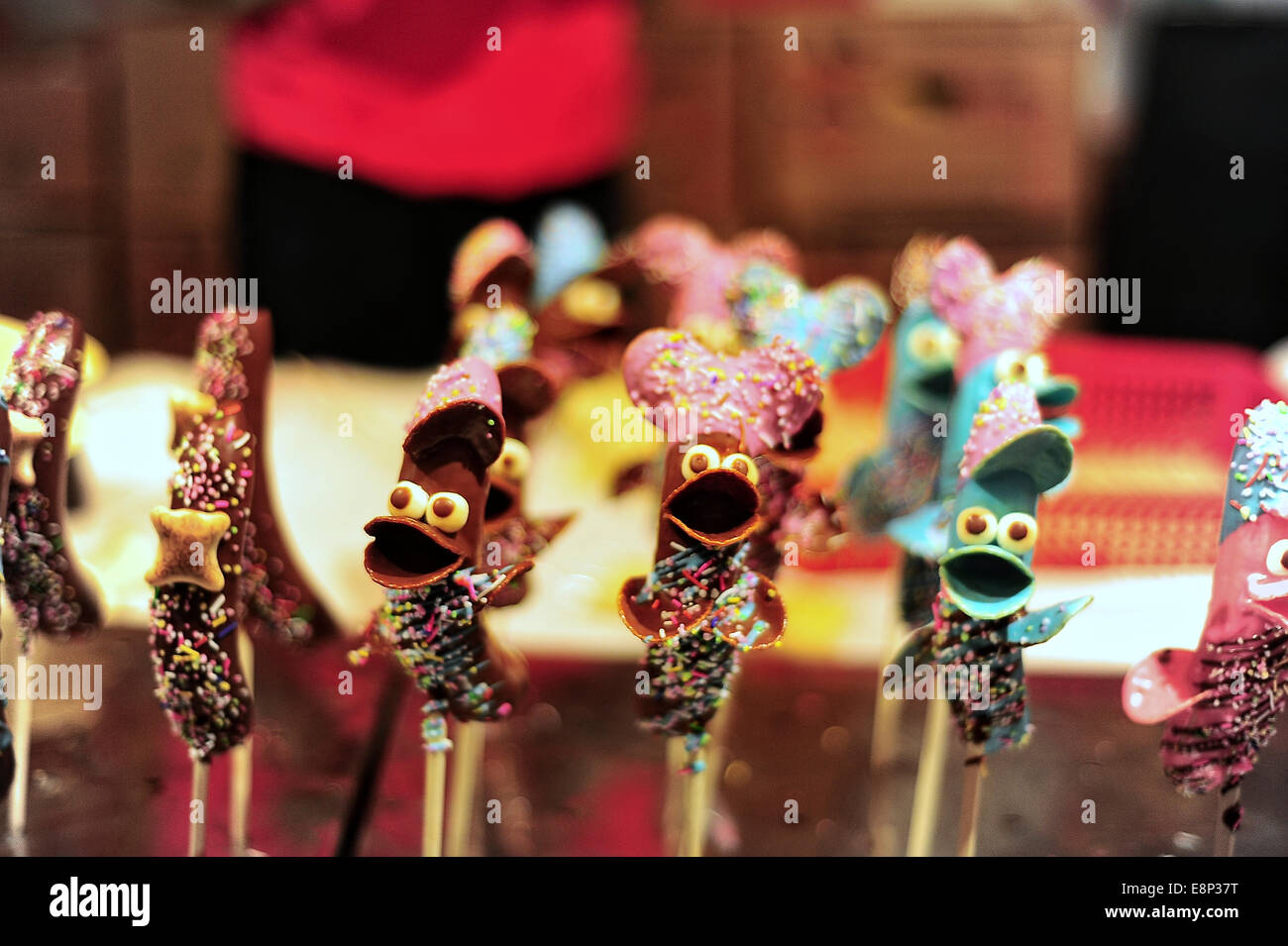 Chocolate covered banana "Character" snacks on skewers at a festival