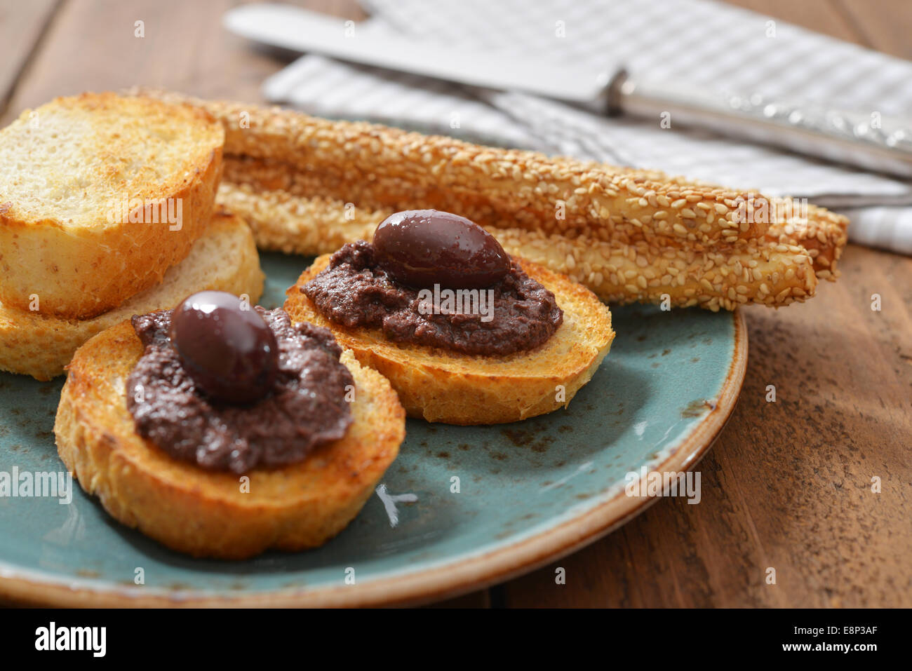 Bread with olive pate on plate closeup. Greek cuisine Stock Photo