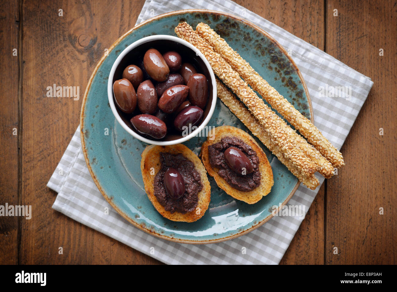 Bread with olive pate on plate closeup. Greek cuisine Stock Photo