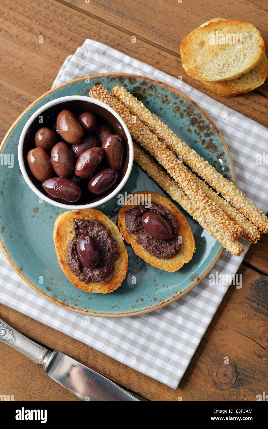 Bread with olive pate on plate closeup. Greek cuisine Stock Photo