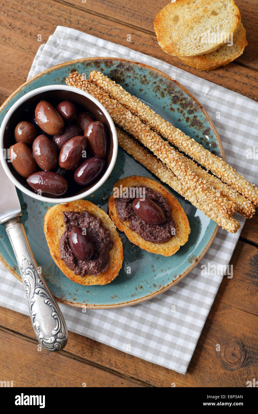 Bread with olive pate on plate closeup. Greek cuisine Stock Photo