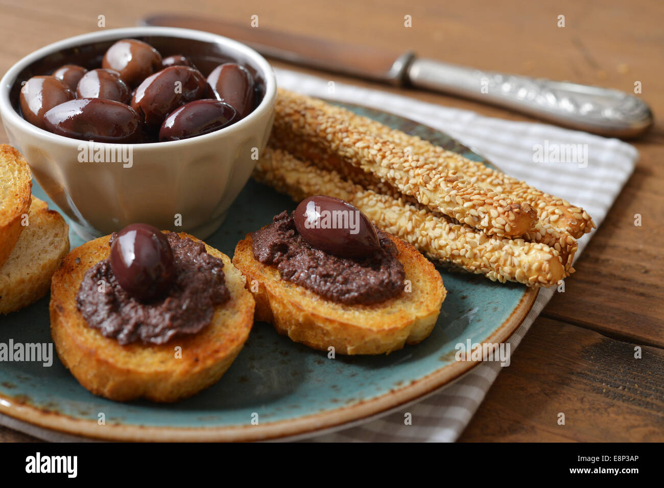 Bread with olive pate on plate closeup. Greek cuisine Stock Photo