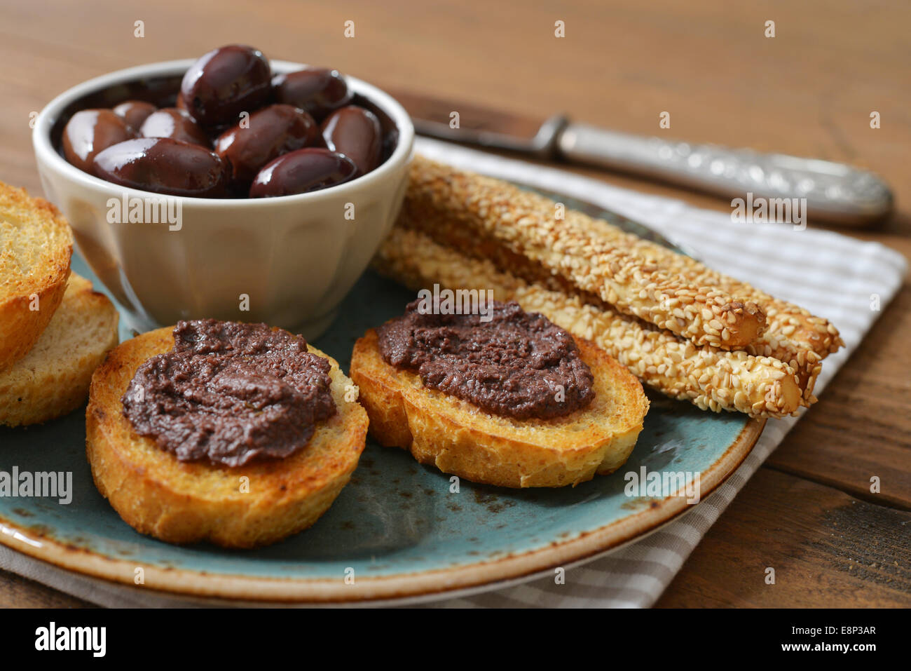 Bread with olive pate on plate closeup. Greek cuisine Stock Photo