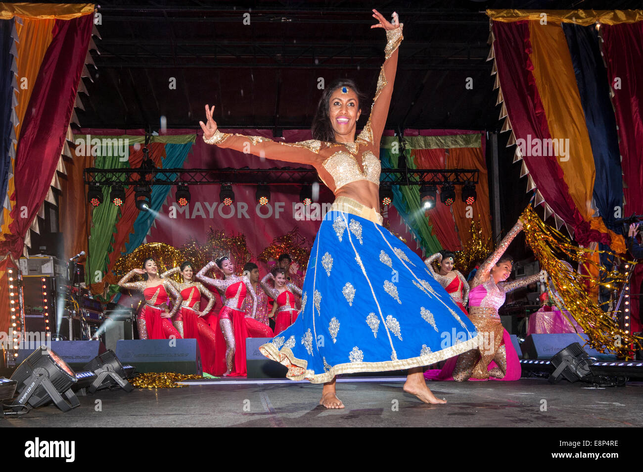 London, UK, 12th October, 2014.  Even as the heavy rain continued to fall, thousands gathered in Trafalgar Square to celebrate the annual Diwali Festival and to enjoy stage performances of traditional and contemporary music and dance.    Credit:  Stephen Chung/Alamy Live News Stock Photo