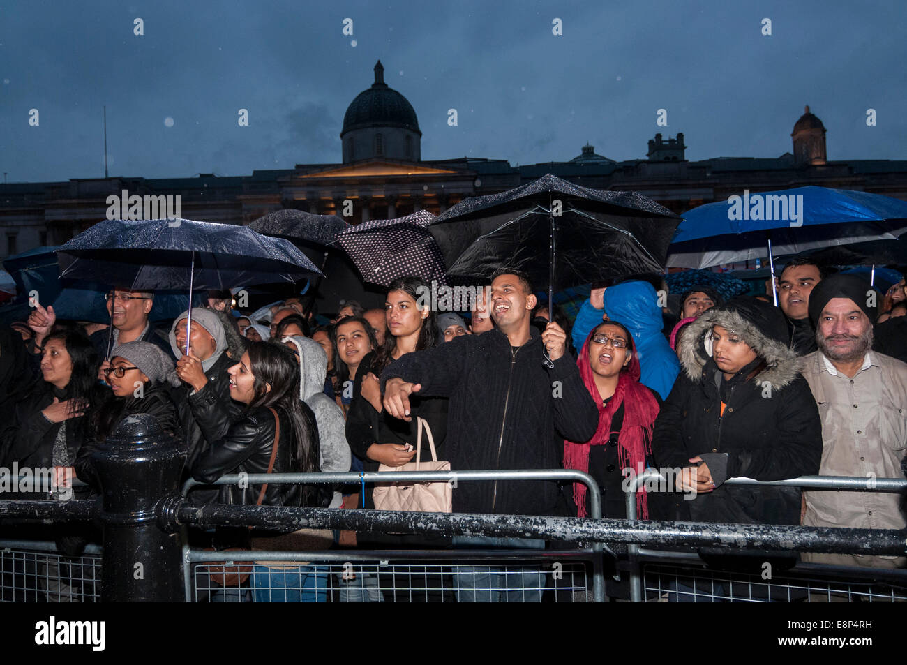 London, UK, 12th October, 2014.  Even though there was heavy rain, thousands gathered in Trafalgar Square to celebrate the annual Diwali Festival and to enjoy stage performances of traditional and contemporary music and dance.    Credit:  Stephen Chung/Alamy Live News Stock Photo