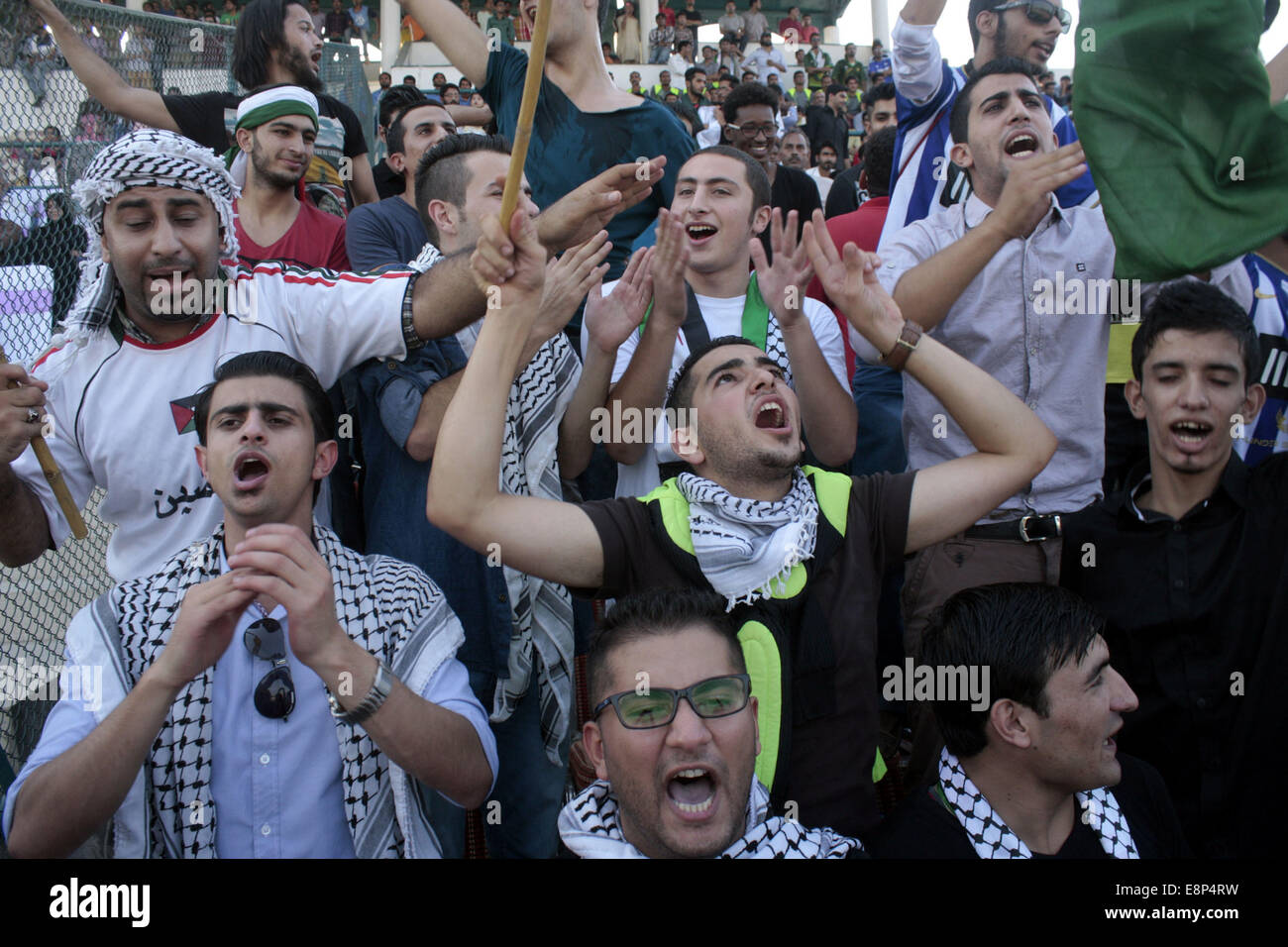 Lahore, Pakistan. 12th Oct, 2014. Palestine's fans cheer during the FIFA Day International Friendly match between Palestine and Pakistan at the Punjab Football Stadium in Lahore, Pakistan, on Oct. 12, 2014. Palestine won 2-0. Credit:  Jamil Ahmed/Xinhua/Alamy Live News Stock Photo